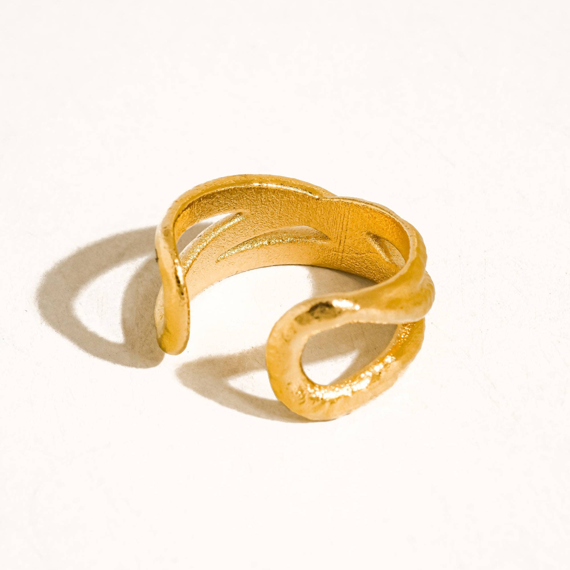 Maison Ella Elowen crossover ring in polished 18k gold plated stainless steel with a textured interwoven design
