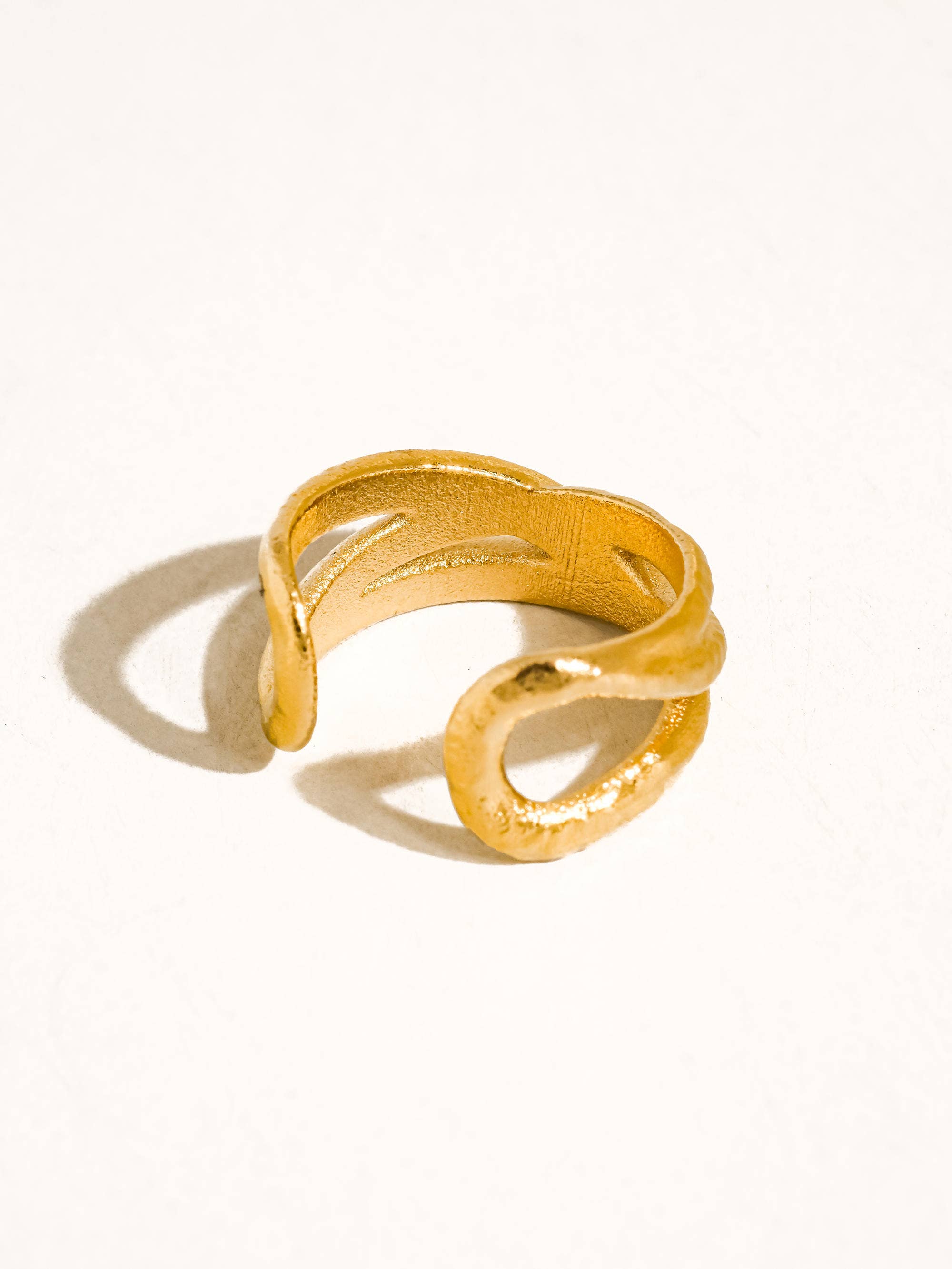 Maison Ella Elowen crossover ring in polished 18k gold plated stainless steel with a textured interwoven design