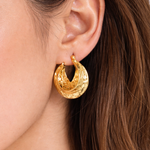 Gold swirl hoop earrings, twisted detail