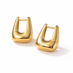Geometric gold hoop earrings, worn