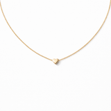 Gold heart-shaped pendant necklace on a white background
