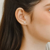Petite sculptural stud earrings crafted from a brass base with premium 18K gold or silver plating, featuring a modern croissant-inspired design. Minimalist and Parisian-chic—perfect for adding a stylish twist to any everyday look. Hypoallergenic, water- and tarnish-resistant.