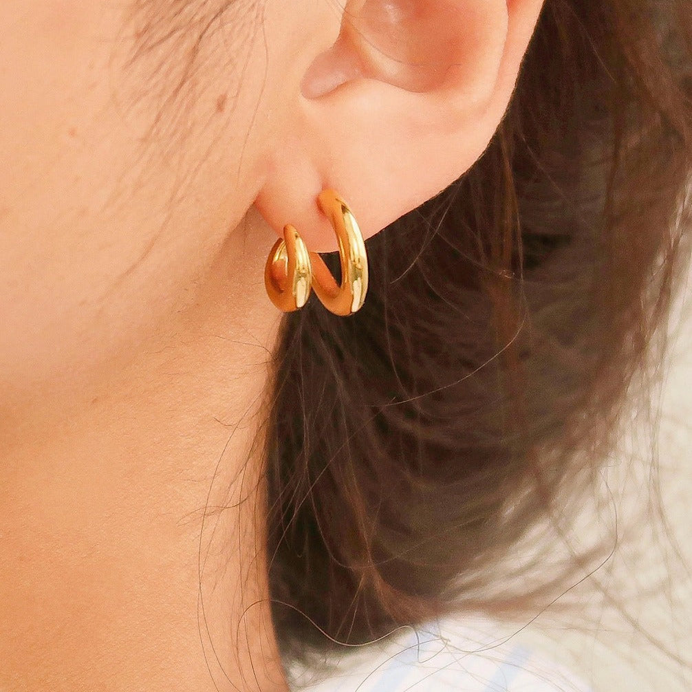 Modern double hoop earrings crafted from premium stainless steel, featuring interlocking double-C design for a structured look. Diameter 0.6 inches. Contemporary, versatile, and chic—perfect for elevating any outfit with bold yet refined style. Hypoallergenic, water- and tarnish-resistant.