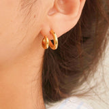 Modern double hoop earrings crafted from premium stainless steel, featuring interlocking double-C design for a structured look. Diameter 0.6 inches. Contemporary, versatile, and chic—perfect for elevating any outfit with bold yet refined style. Hypoallergenic, water- and tarnish-resistant.