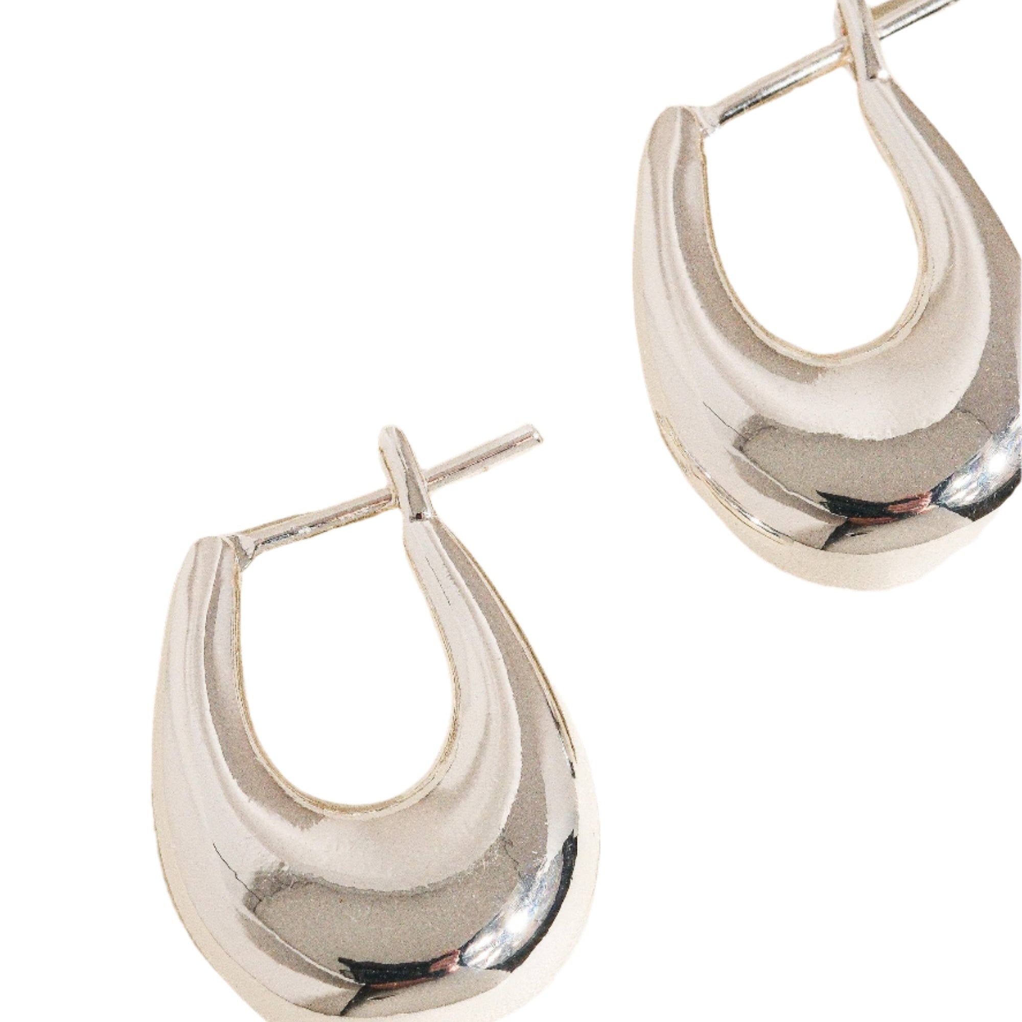 Gold droplet hoop earrings with a gently curved silhouette and smooth, polished finish. Crafted from 18K gold-plated brass, measuring 1 x 0.7 inches. Hypoallergenic, water- and tarnish-resistant—ideal for effortless everyday elegance.