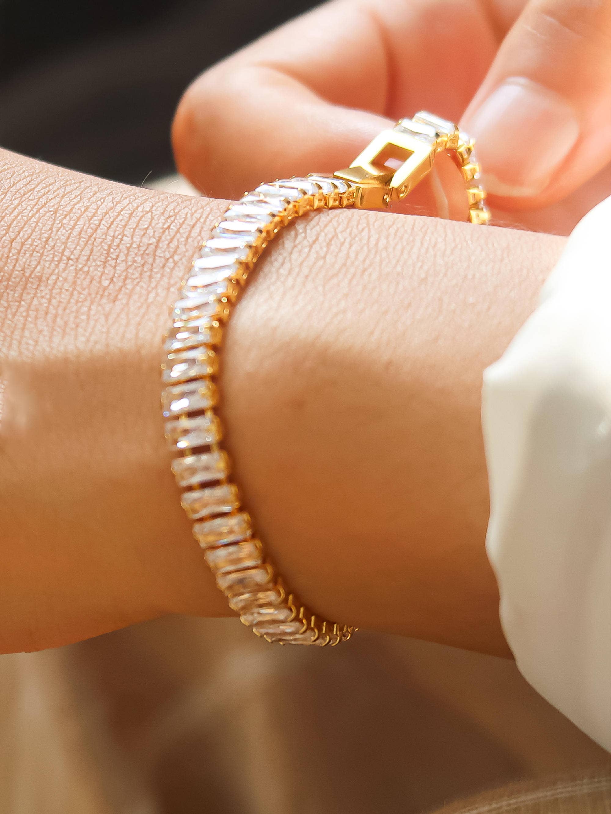 Elegant bracelet crafted from stainless steel with 18K gold plating, featuring high-quality cubic zirconia for brilliant sparkle. Chain length 6.8 inches with extender for adjustable fit. Hypoallergenic, water- and tarnish-resistant—perfect for adding instant shine and effortless elegance to any stack.