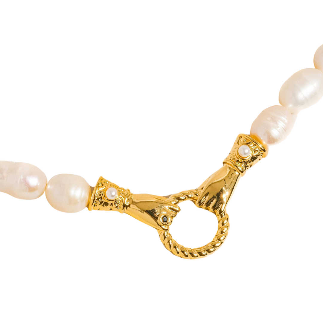 Elegant necklace crafted from a brass base with premium 18K gold plating, featuring a natural freshwater pearl delicately nested within a polished circular hoop pendant. Hypoallergenic, water- and tarnish-resistant—perfect for adding timeless elegance and symbolic connection to any look. 