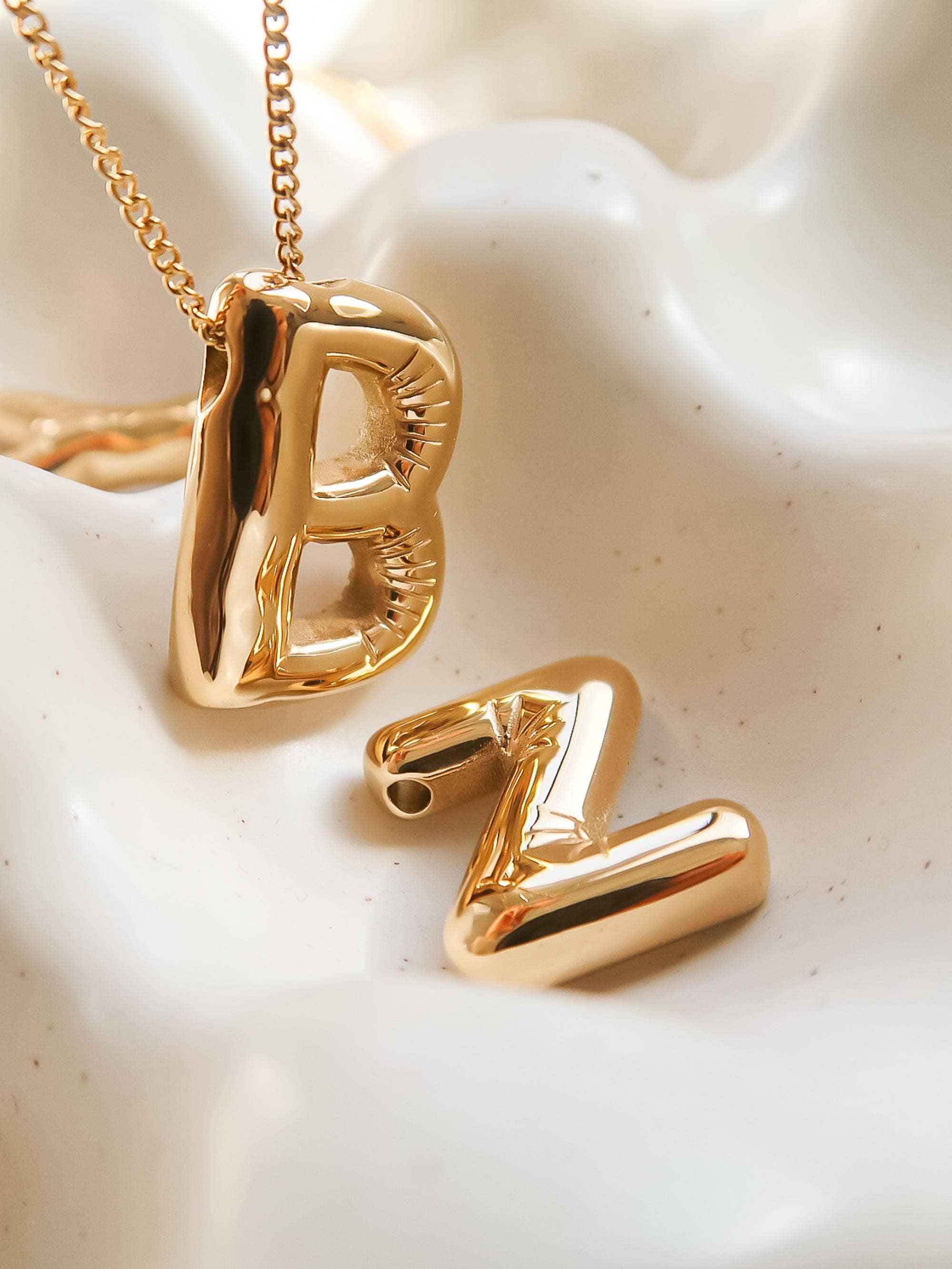 Playful necklace crafted from premium stainless steel with 18K gold plating, featuring a balloon-style alphabet letter pendant (0.8 inch). Chain length 16 inches plus 2-inch extender. Hypoallergenic, water- and tarnish-resistant—perfect for adding a personal and whimsical touch to any look