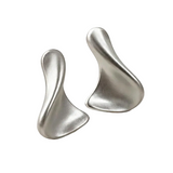 A pair of abstract sculptural stud earrings in a brushed silver finish, displayed on a clean white background.