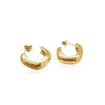 Gold classic C-shaped hoop earrings, worn