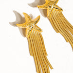 Gold star tassel drop earrings, detail view